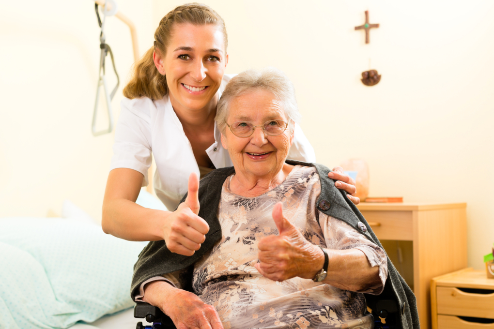 Nurse and an elderly doing a thumbs-up sign